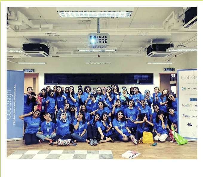 Large group of participants in blue t-shirts at the CoD3sign workshop.